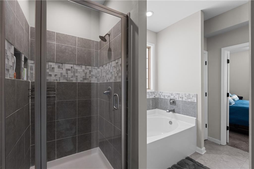 2117 Treehaven Court Decatur, GA 30035 - Photo 12 of 23 a bathroom with a bathtub and a shower