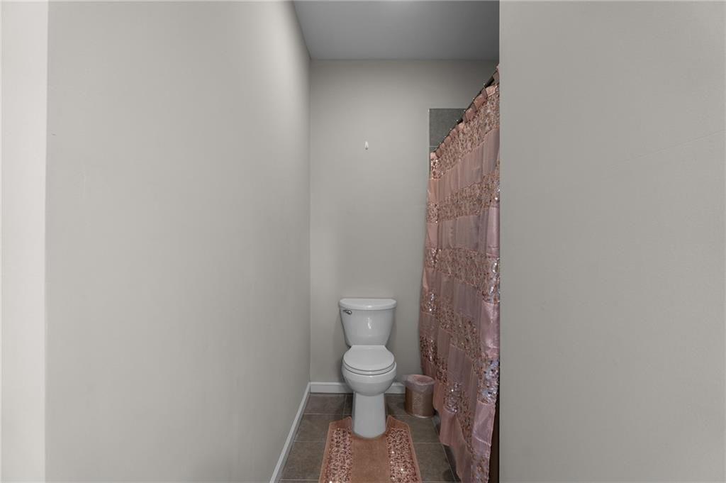 2117 Treehaven Court Decatur, GA 30035 - Photo 14 of 23 a bathroom with a toilet and a shower curtain