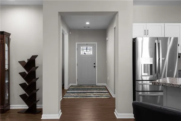 a view of kitchen with furniture and refrigerator