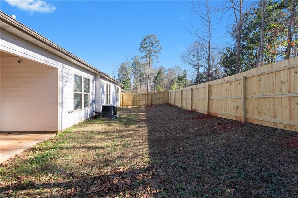 2117 Treehaven Court Decatur, GA 30035 - Photo 22 of 23 a view of a backyard with large trees and wooden fence