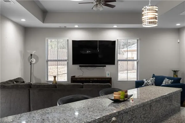 a living room with furniture a flat screen tv and window