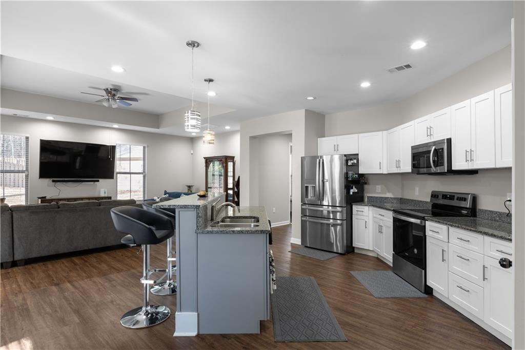 2117 Treehaven Court Decatur, GA 30035 - Photo 5 of 23 a living room with stainless steel appliances furniture and a flat screen tv