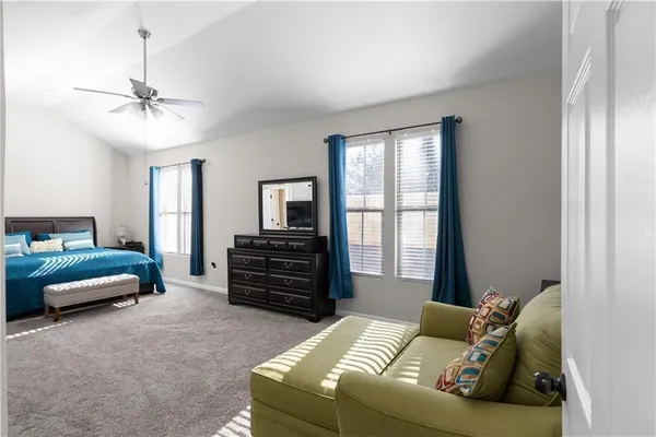 a bedroom with a bed and a ceiling fan