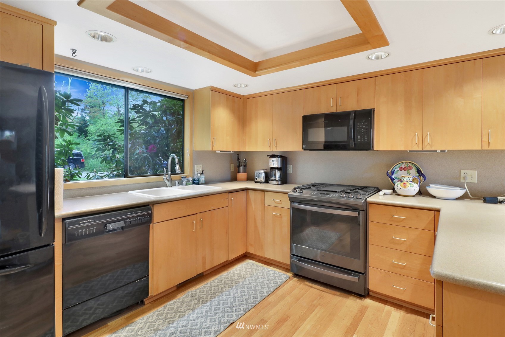 201 Middlefield Road Bellingham, WA 98225 - Photo 18 of 36 a kitchen with a stove a sink and a microwave