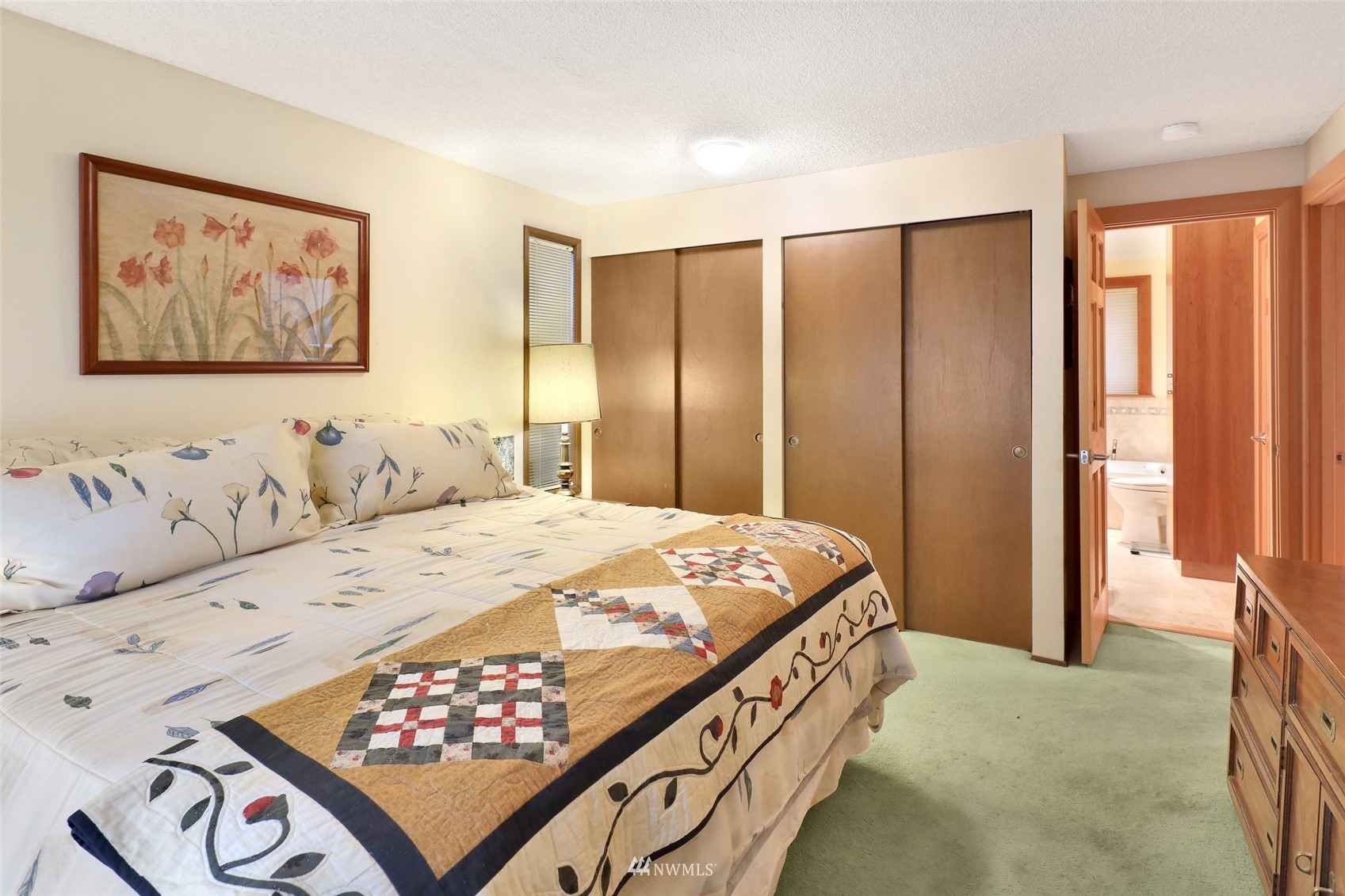 201 Middlefield Road Bellingham, WA 98225 - Photo 25 of 36 a bedroom with a bed and a painting on the wall