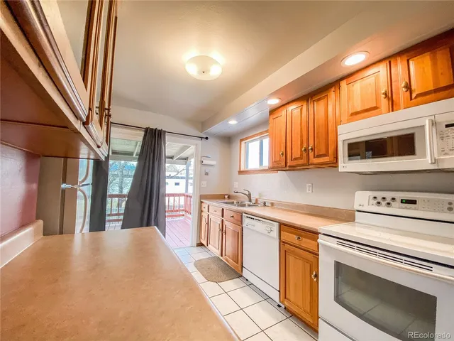 a kitchen with stainless steel appliances a stove a sink and a refrigerator
