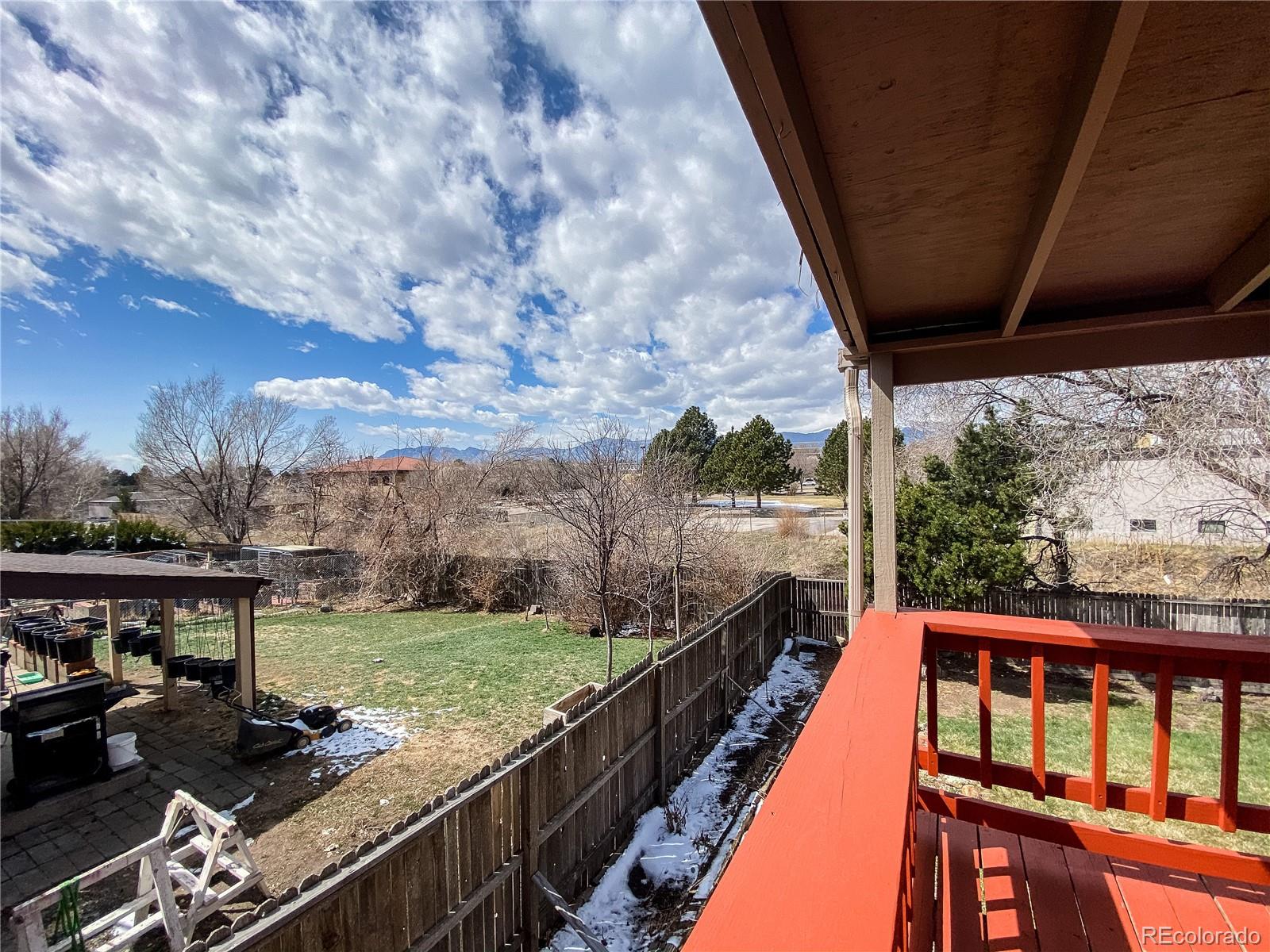 2214 Wold Avenue Colorado Springs, CO 80909 - Photo 18 of 38 a balcony with wooden floor and outdoor seating