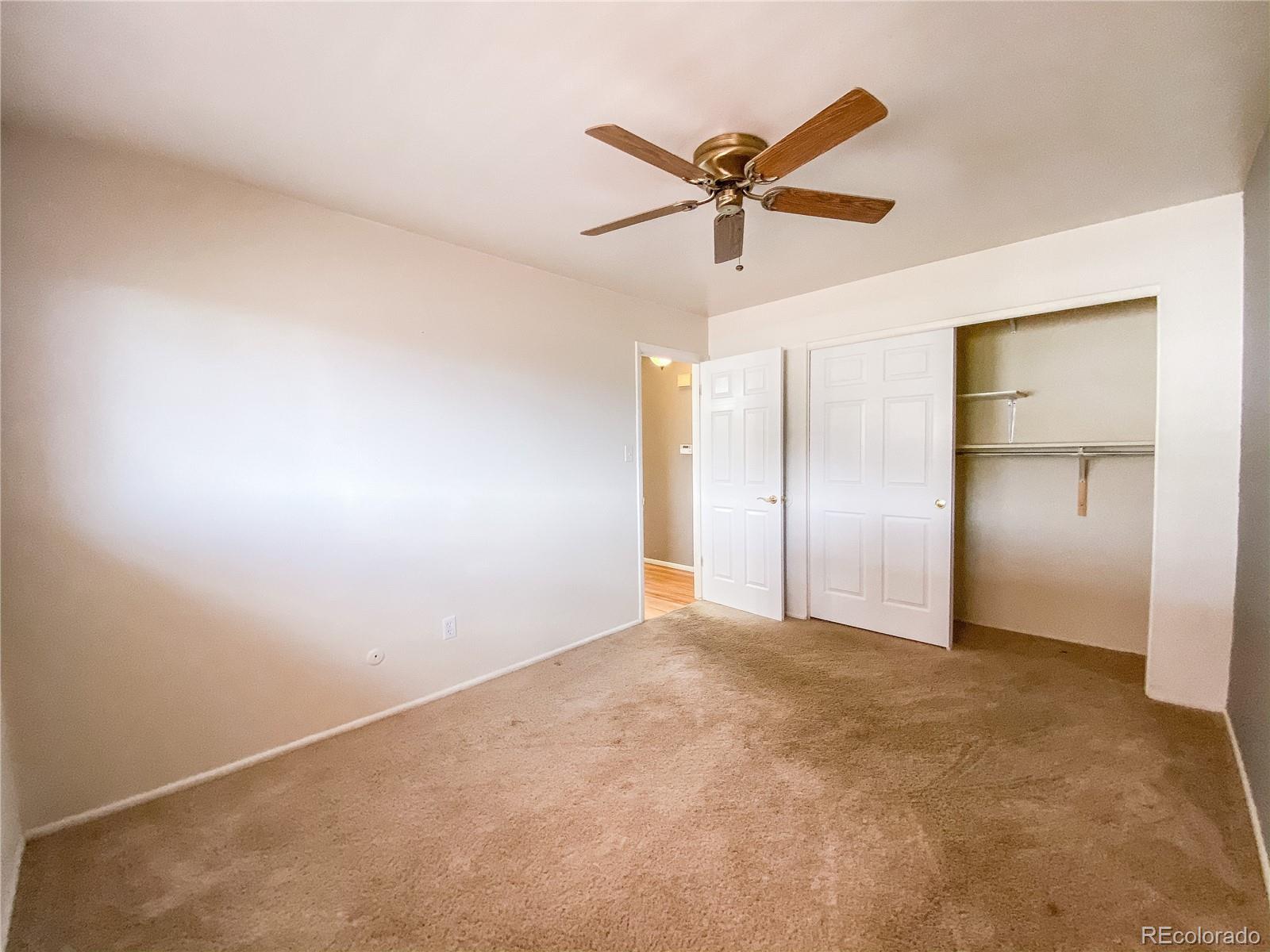 2214 Wold Avenue Colorado Springs, CO 80909 - Photo 20 of 38 a view of a big room with a chandelier fan and windows