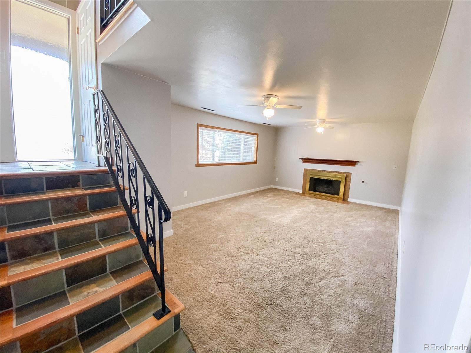 2214 Wold Avenue Colorado Springs, CO 80909 - Photo 27 of 38 a view of an empty room with wooden floor and a window