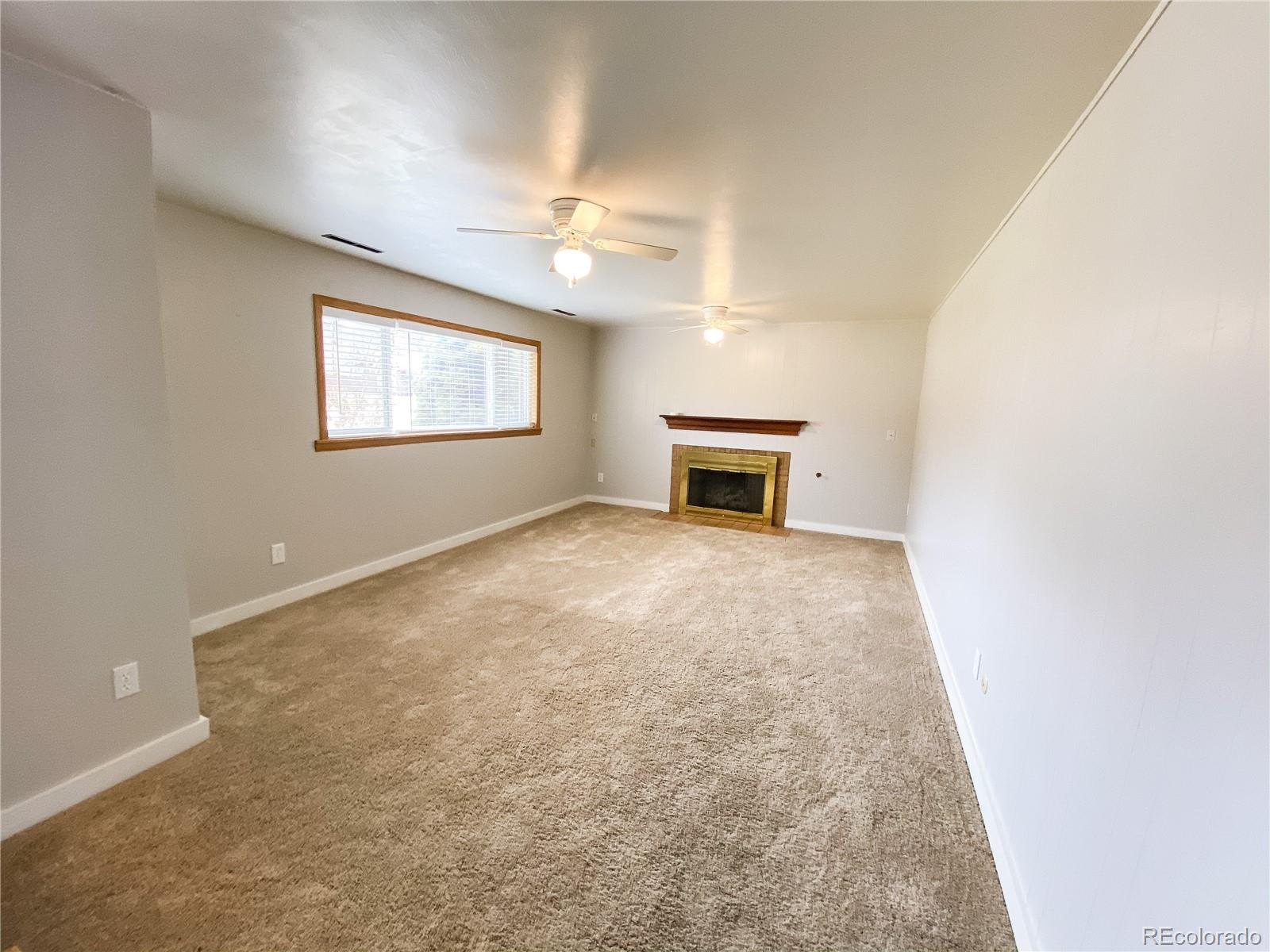 2214 Wold Avenue Colorado Springs, CO 80909 - Photo 28 of 38 an empty room with windows and ceiling fan