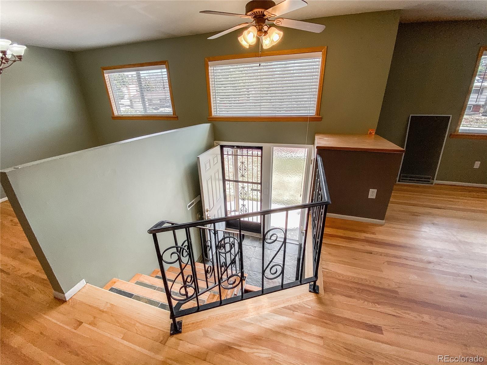 2214 Wold Avenue Colorado Springs, CO 80909 - Photo 3 of 38 a view of a hallway with wooden floor and windows