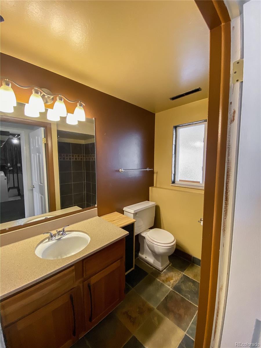 2214 Wold Avenue Colorado Springs, CO 80909 - Photo 34 of 38 a bathroom with a sink and a mirror