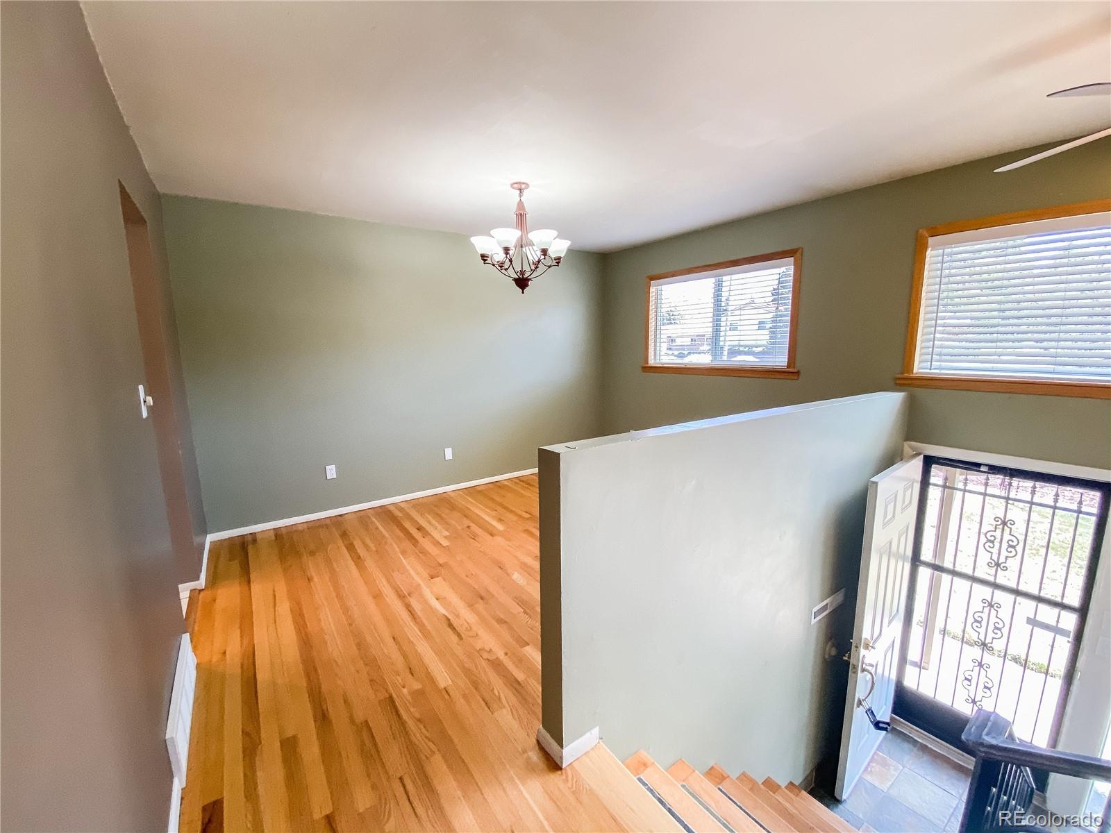 2214 Wold Avenue Colorado Springs, CO 80909 - Photo 5 of 38 a view of an empty room with window and wooden floor