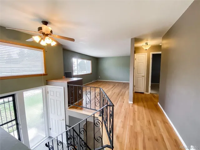 a view of entryway and hall with wooden floor