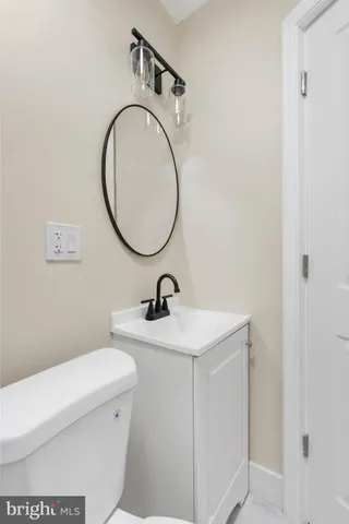 a bathroom with a sink a toilet and a mirror