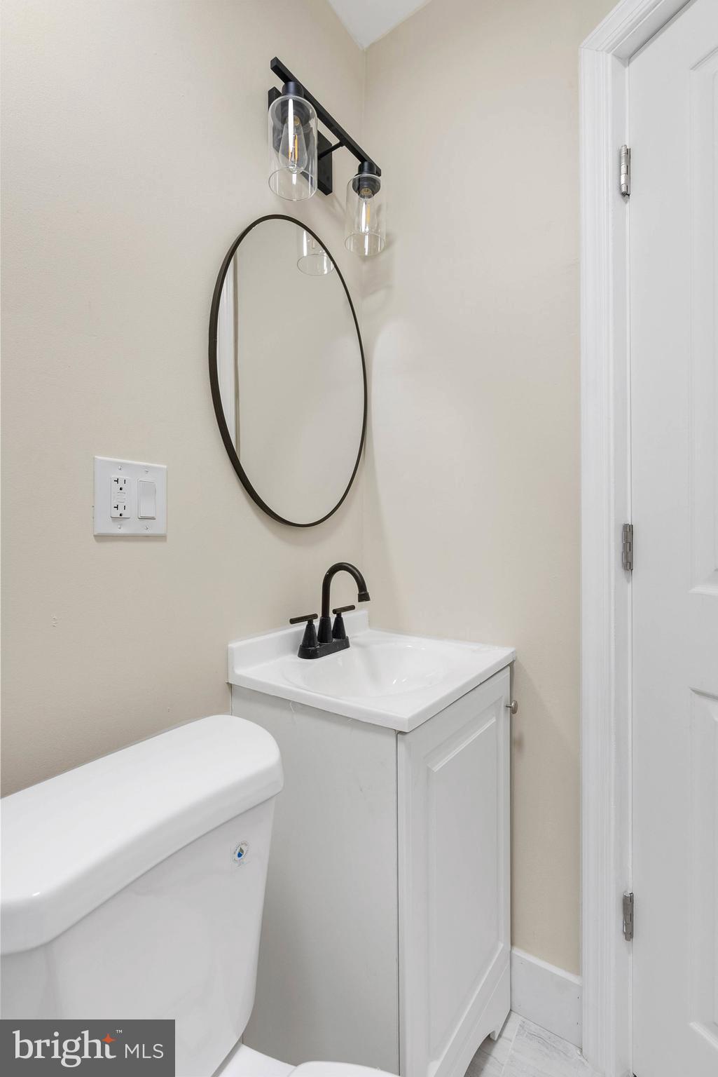 1221 North 50th Street Philadelphia, PA 19131 - Photo 19 of 24 a bathroom with a sink a toilet and a mirror