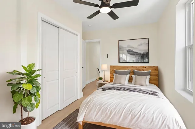 a bedroom with a bed and a potted plant