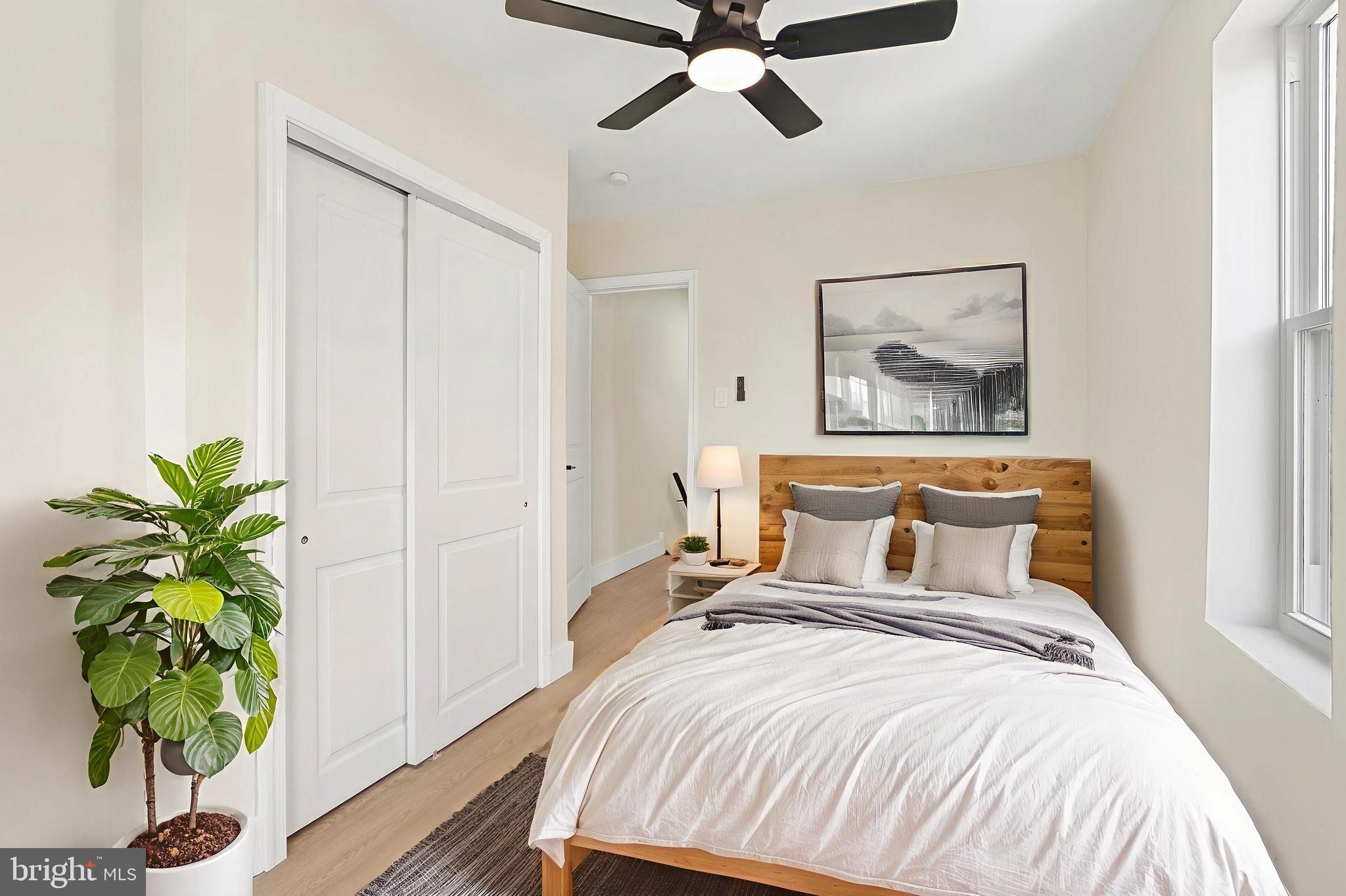 1221 North 50th Street Philadelphia, PA 19131 - Photo 20 of 24 a bedroom with a bed and a potted plant
