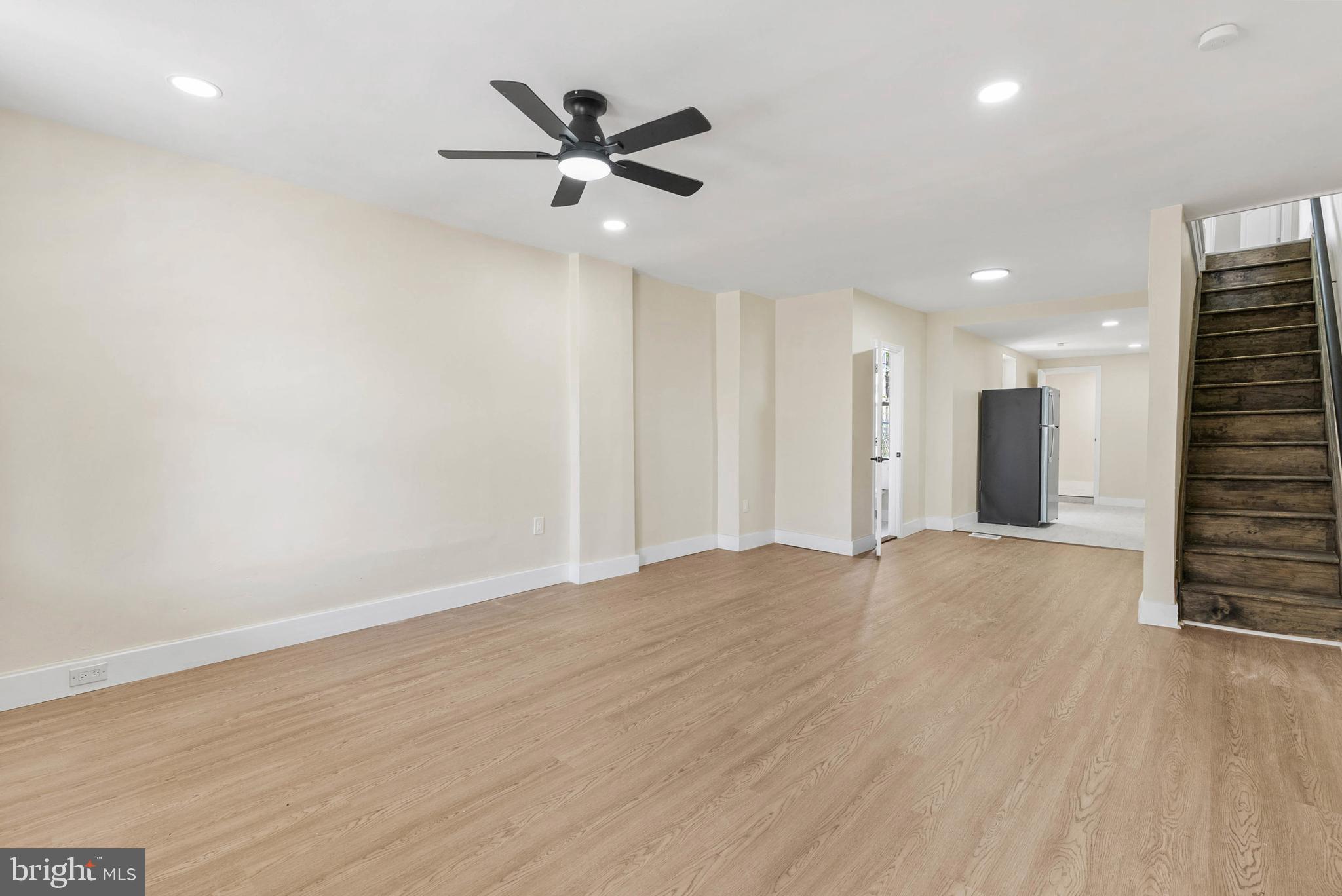 1221 North 50th Street Philadelphia, PA 19131 - Photo 2 of 24 an empty room with wooden floor and a ceiling fan