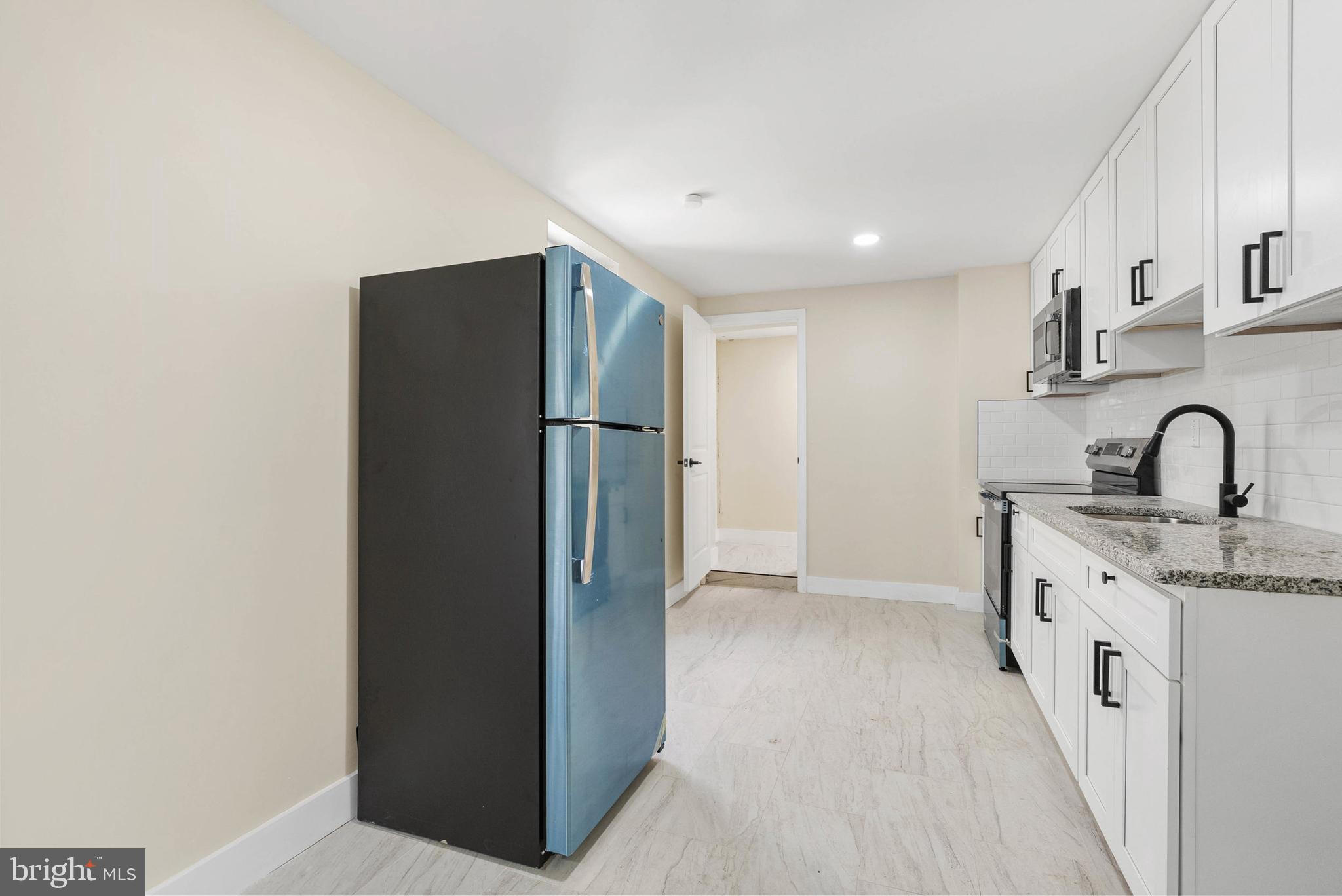 1221 North 50th Street Philadelphia, PA 19131 - Photo 8 of 24 a kitchen with refrigerator and sink