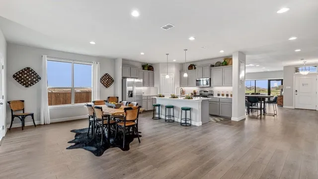 a kitchen with stainless steel appliances granite countertop a stove a microwave and cabinets