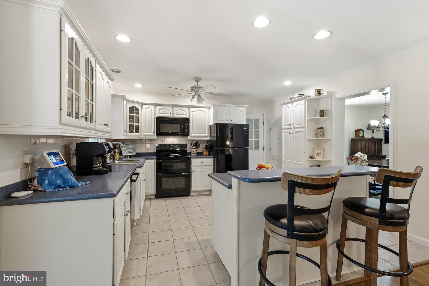 814 Wrights Neck Road Centreville, MD 21617 - Photo 36 of 53 a kitchen with a sink a kitchen island and stainless steel appliances