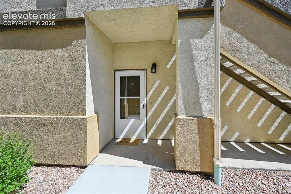 3715 Riviera Grove, Unit 101 Colorado Springs, CO 80922 - Photo 6 of 36 Entryway featuring a white door with glass inserts, recessed overhead lighting, and a black wall-mounted fixture