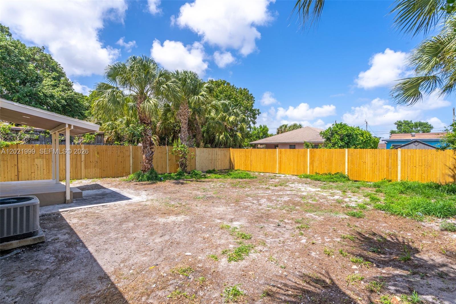 1660 West 26th Street Riviera Beach, FL 33404 - Photo 24 of 28 a view of a backyard with large tree