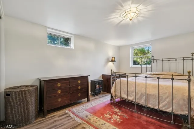 a bed sitting in a bedroom next to a window with a dresser