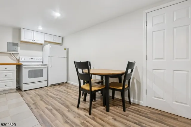 a view of a kitchen with a dining table and chairs