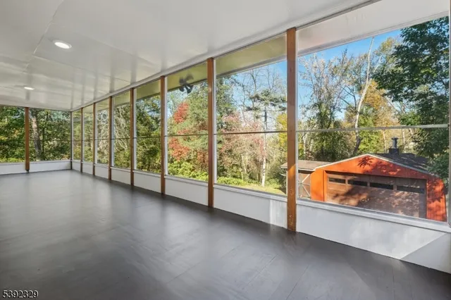 en empty room with sliding door and wooden floor
