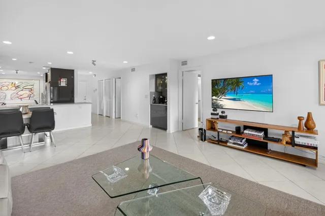 an aerial view of residential houses with outdoor space and lake view