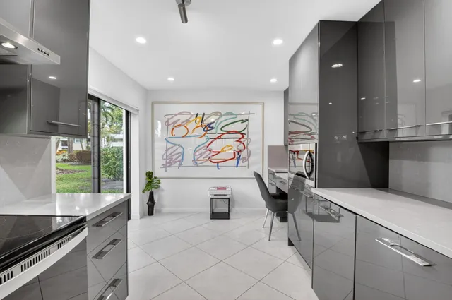 a kitchen with stainless steel appliances kitchen island granite countertop a sink a stove and cabinets
