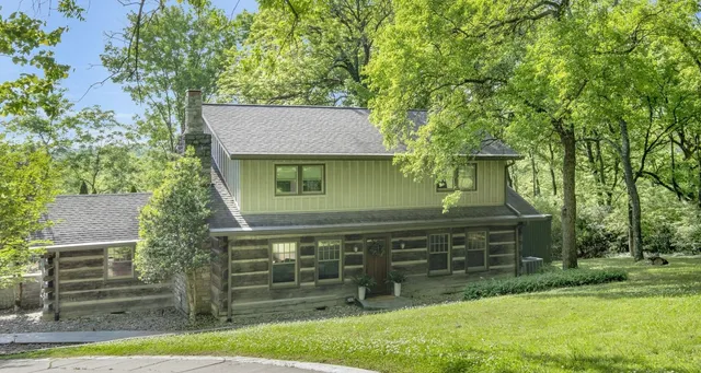 a front view of a house with a garden