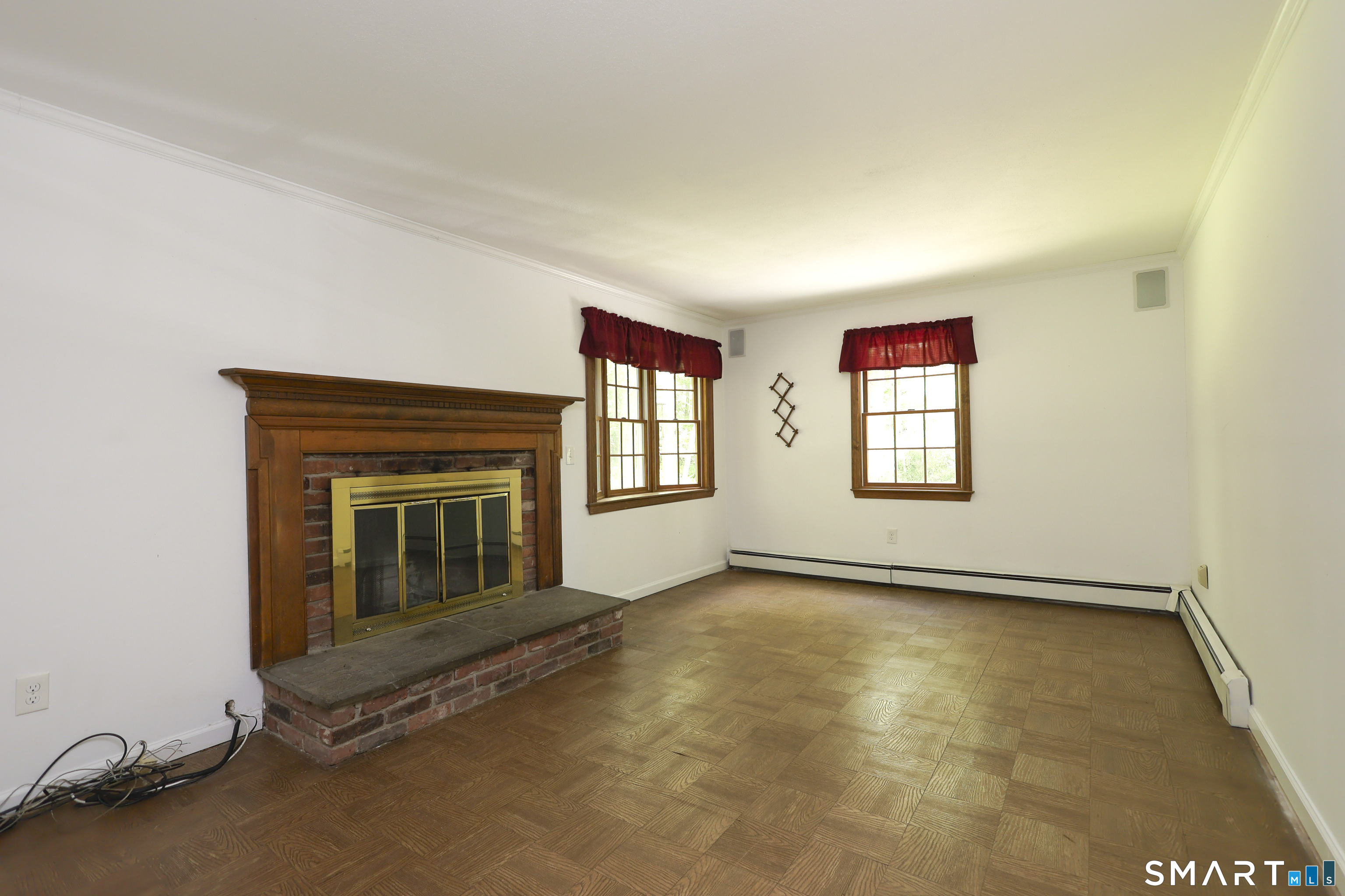 145 Wilton Road East Ridgefield, CT 06877 - Photo 14 of 37 Family room with fireplace and parquet floors.