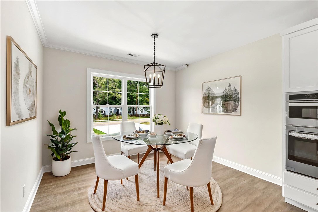 1735 Maw Bridge Road Central, SC 29630 - Photo 18 of 42 A well-appointed dining area offers an inviting space for meals, complemented by views of the outdoors.