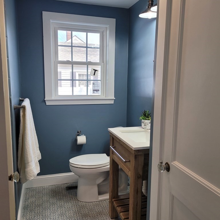 114 Conant Street Danvers, MA 01923 - Photo 19 of 29 a bathroom with a toilet a sink and a window