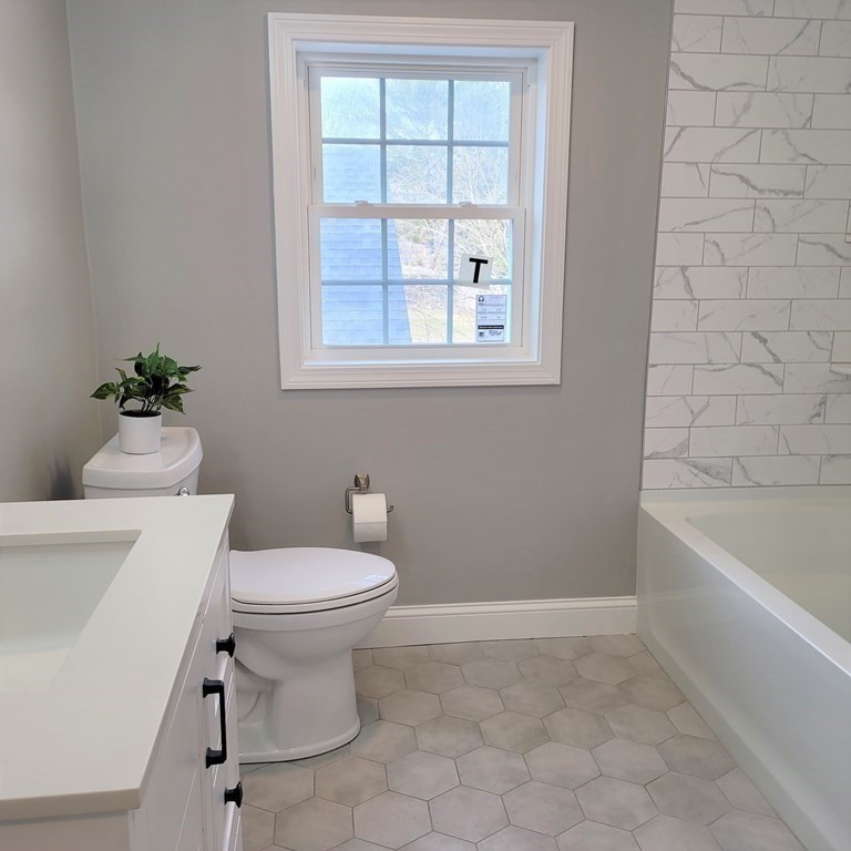 114 Conant Street Danvers, MA 01923 - Photo 26 of 29 a bathroom with a toilet sink and bathtub