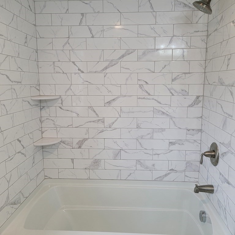 114 Conant Street Danvers, MA 01923 - Photo 27 of 29 a bathroom with a white bathtub and a shower