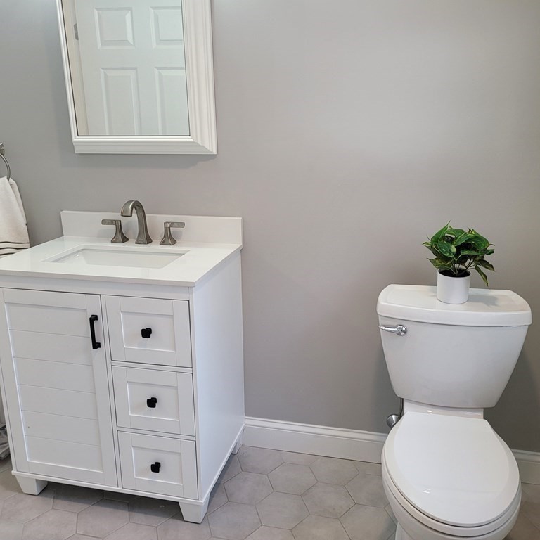 114 Conant Street Danvers, MA 01923 - Photo 28 of 29 a bathroom with a toilet sink and mirror