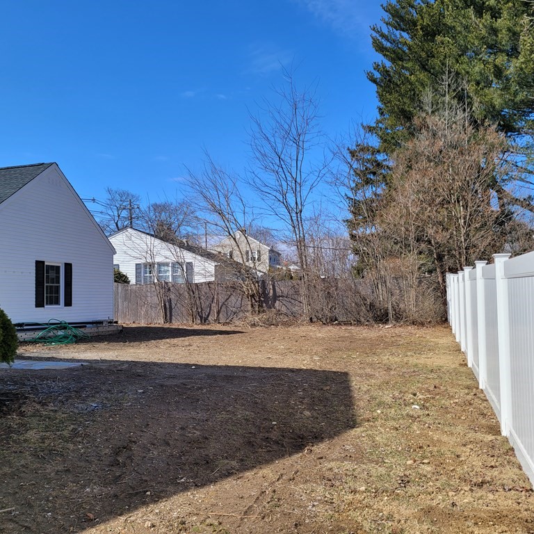 114 Conant Street Danvers, MA 01923 - Photo 5 of 29 a view of a yard with wooden fence