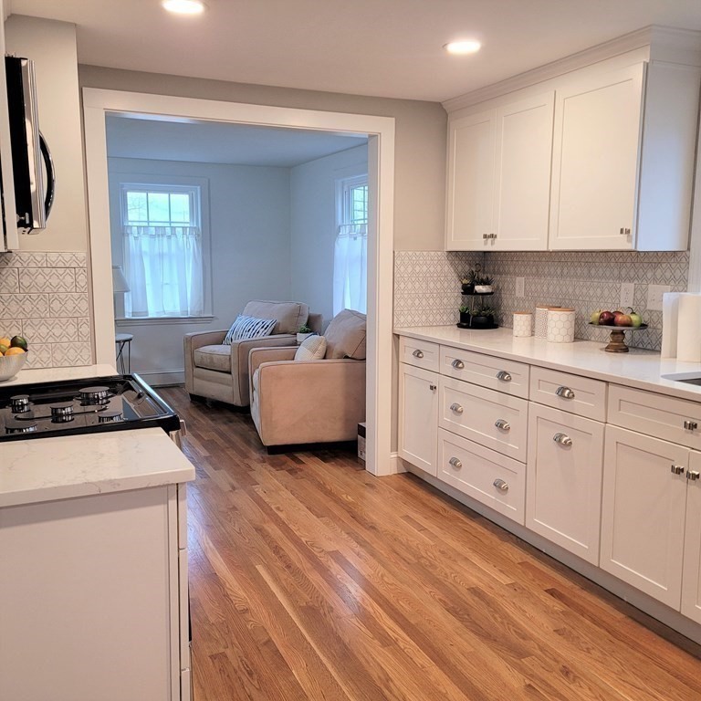 114 Conant Street Danvers, MA 01923 - Photo 6 of 29 a kitchen with stainless steel appliances white cabinets and a window
