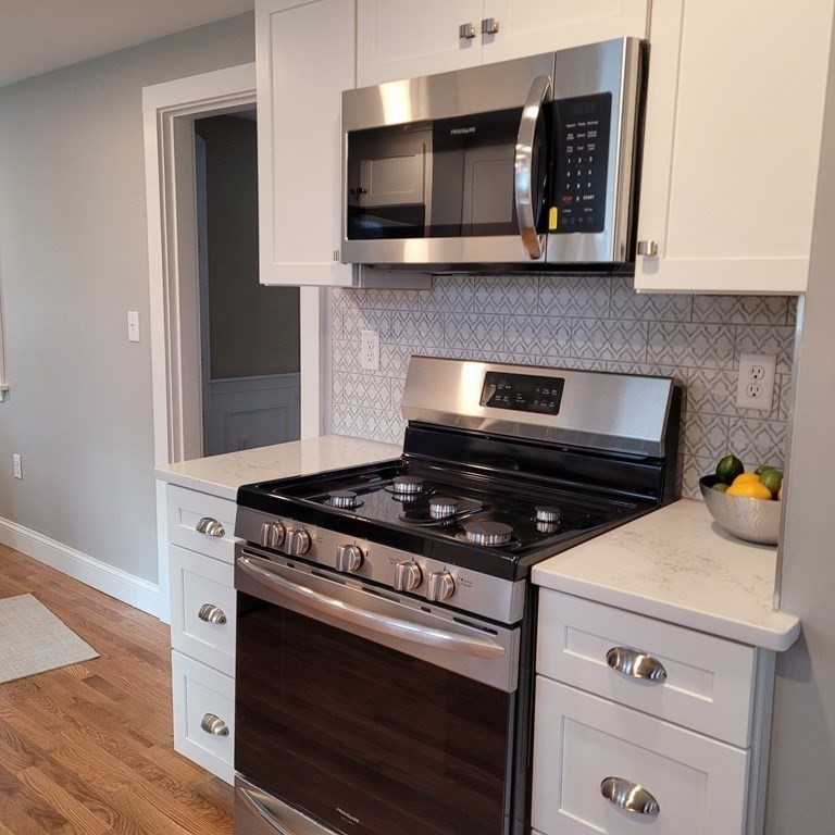 114 Conant Street Danvers, MA 01923 - Photo 10 of 29 a kitchen with a stove and a microwave