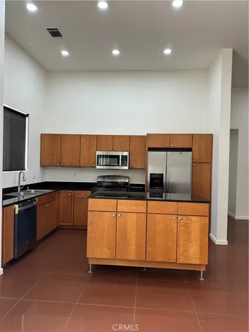 a kitchen with stainless steel appliances granite countertop a sink and a stove