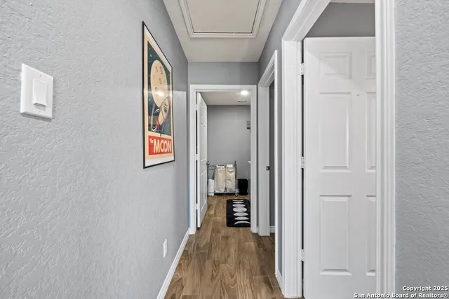 a view of a hallway with wooden floor