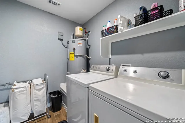 a bathroom with a sink vanity mirror and toilet
