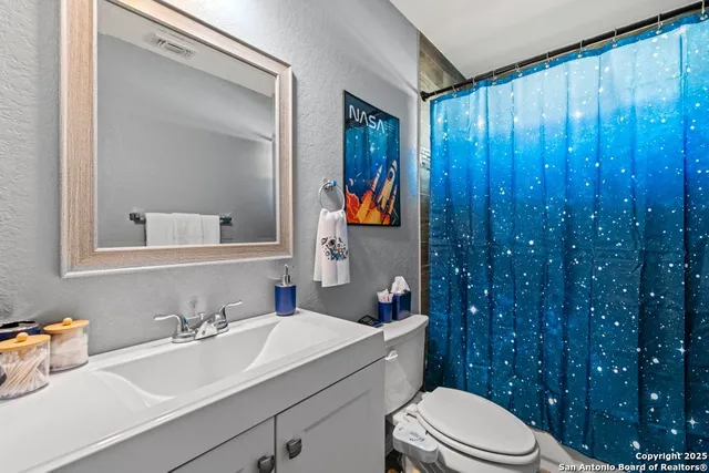 a bedroom with furniture and a chandelier