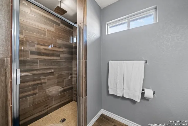 a room with stainless steel appliances wooden floor