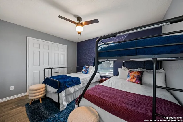 a bedroom with a bed and wooden floor