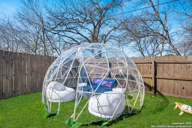 a view of backyard with a slide and a bench